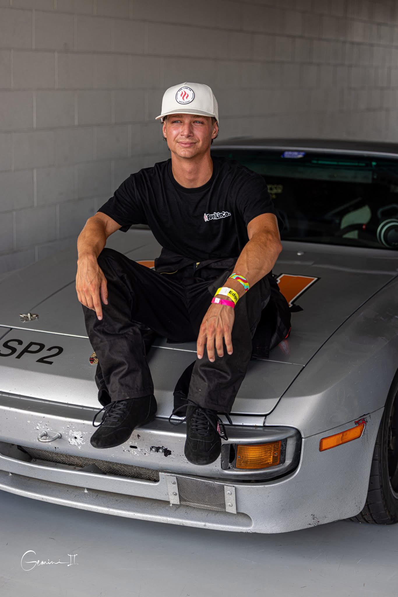 Ryder Plouffe sitting on the FuelLine Racing Porsche 944